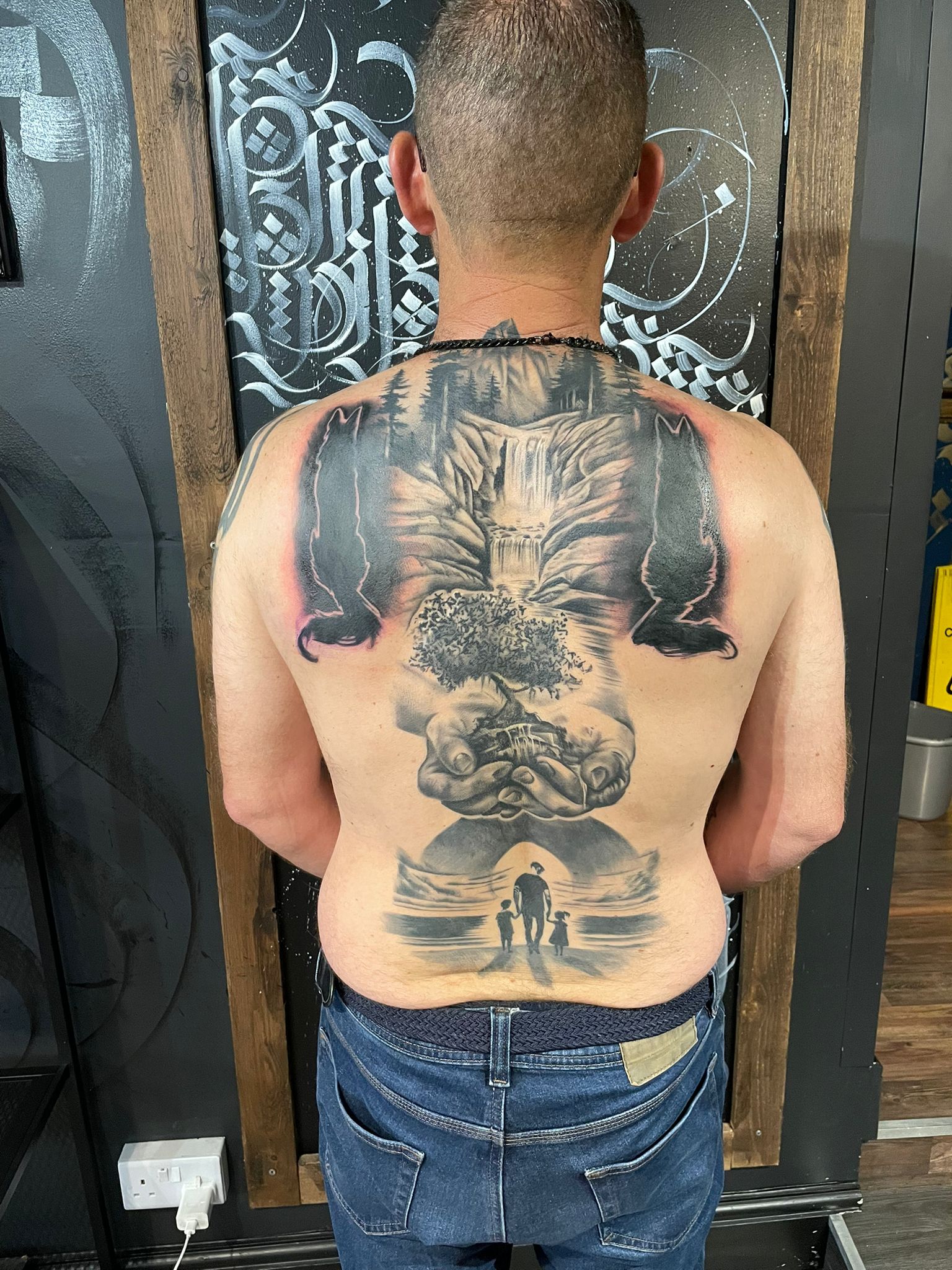 Large black and grey back piece tattoo by Michael Lisney