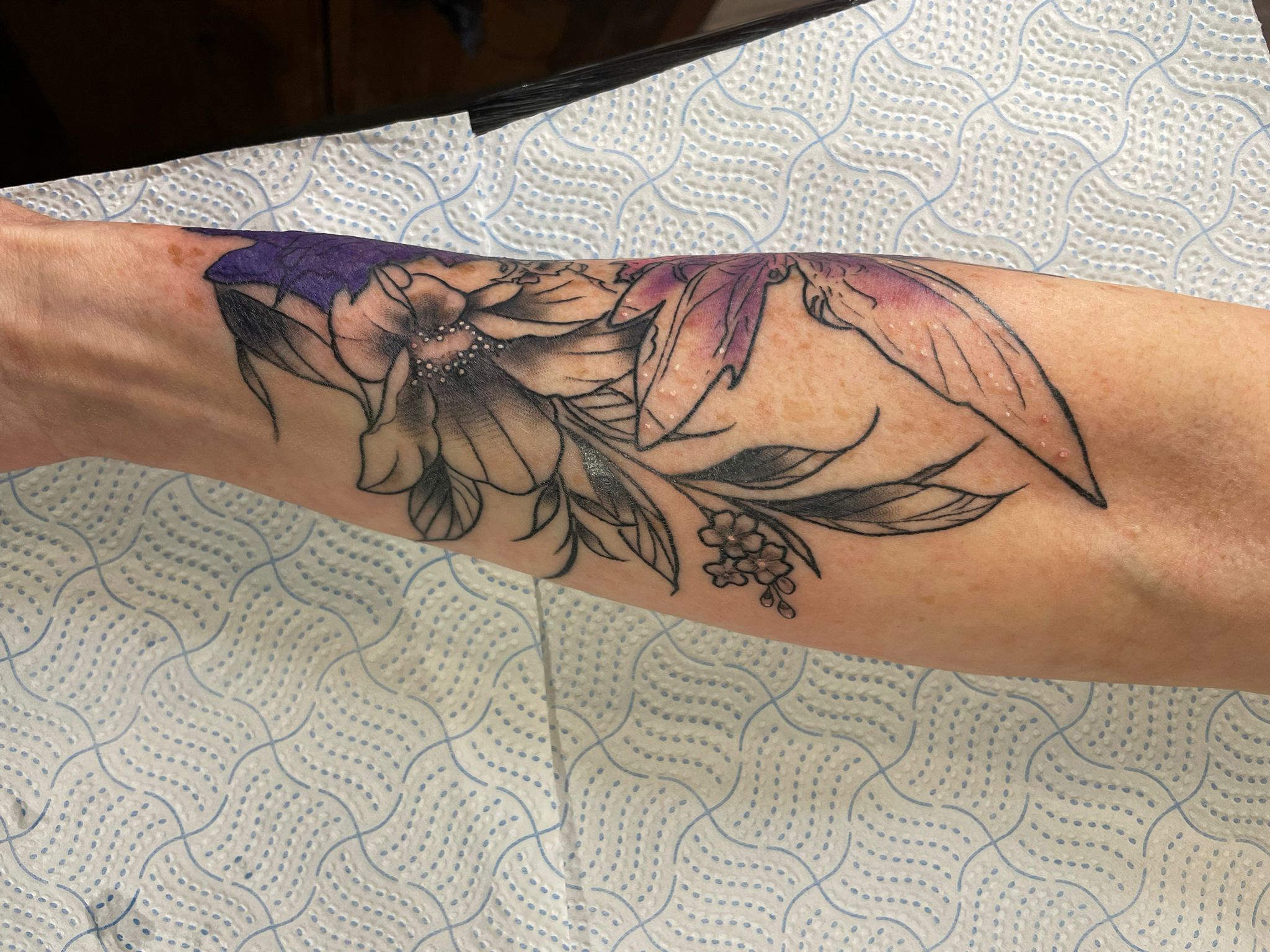 Floral botanical tattoo by Michael Lisney